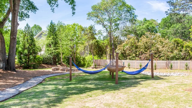 Hammock area with stone fire pit exterior at Landmark Athens in Athens Student Accommodation
