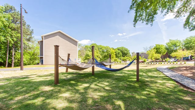 Hammocks on poles near building exterior at Landmark Athens in Athens Student Accommodation