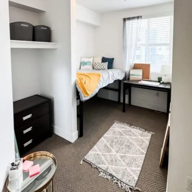 Bed dresser desk rug and shelving bedroom at Promenade Place in Orem Student Accommodation