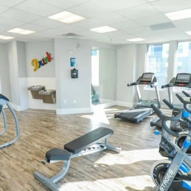 Treadmills exercise bikes weight bench gym at Promenade Place in Orem Student Accommodation