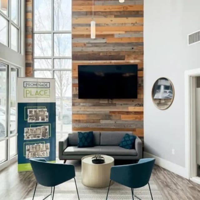 Sofa coffee table chairs and television common area at Promenade Place in Orem Student Accommodation