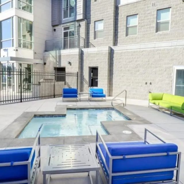 Pool with blue chairs and green couch outdoor area at Promenade Place in Orem Student Accommodation