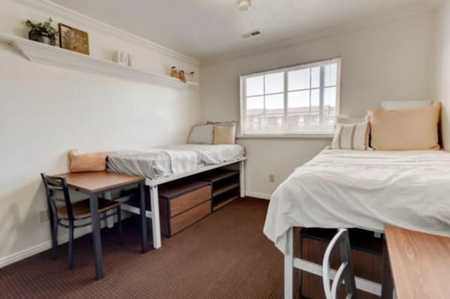 Two beds desk storage shelves bedroom at The Colonial House in Rexburg Student Accommodation