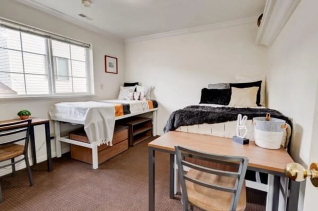 Two beds desks and storage Bedroom at The Colonial House in Rexburg Student Accommodation