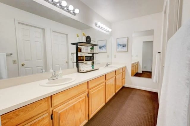 Double sinks wooden cabinets artwork and towels bathroom at The Colonial House in Rexburg Student Accommodation