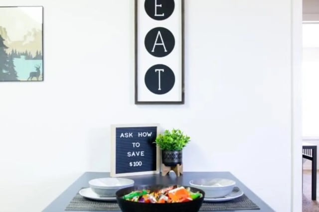 Dining table with food and plant dining area at Nauvoo House Apartments in Rexburg Student Accommodation
