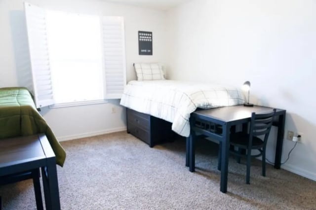 Beds desks and chairs with blinds bedroom at Nauvoo House Apartments in Rexburg Student Accommodation