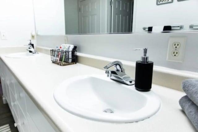 Two sinks soap dispenser toiletries towels bathroom at Nauvoo House Apartments in Rexburg Student Accommodation