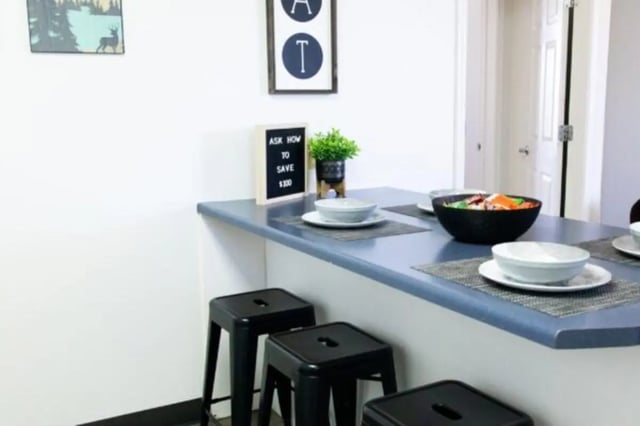 Bar stools and table setting in a dining area at Nauvoo House Apartments in Rexburg Student Accommodation