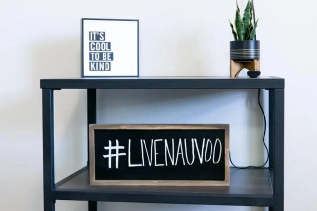 Quote framed and chalkboard sign shelf unit at Nauvoo House Apartments in Rexburg Student Accommodation