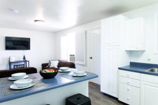 Table with place settings and kitchen cabinets living room at Nauvoo House Apartments in Rexburg Student Accommodation