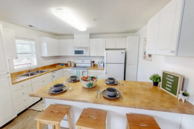 Kitchen with island bar and stools kitchen at Nauvoo House Apartments in Rexburg Student Accommodation