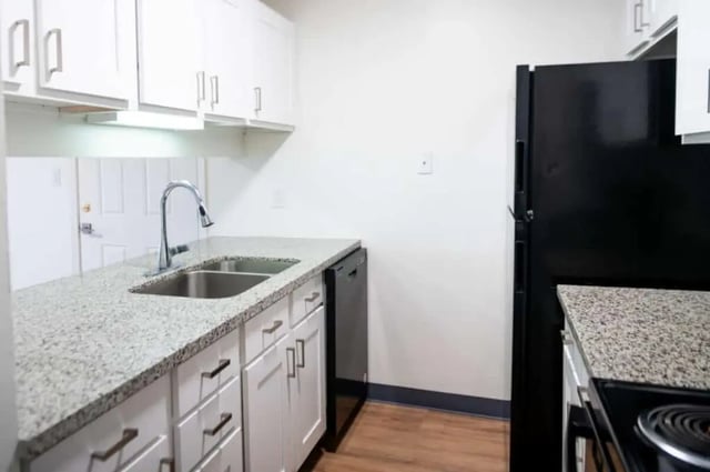 Kitchen cabinets sink dishwasher refrigerator kitchen at Silvertree Communities in Muncie Student Accommodation