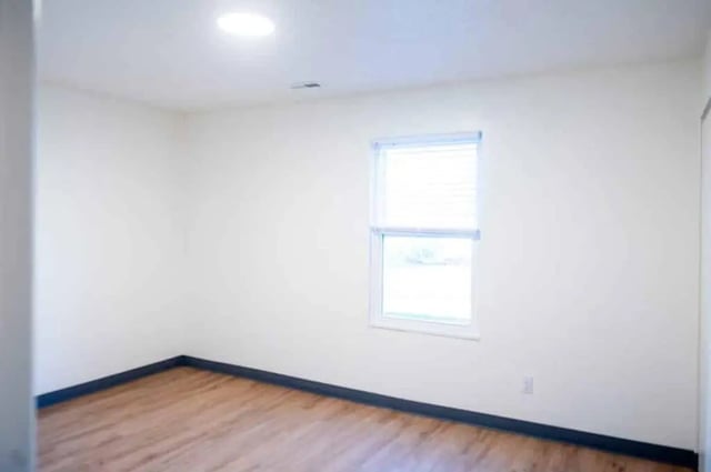 Empty room with wood floor and window Bedroom at Silvertree Communities in Muncie Student Accommodation