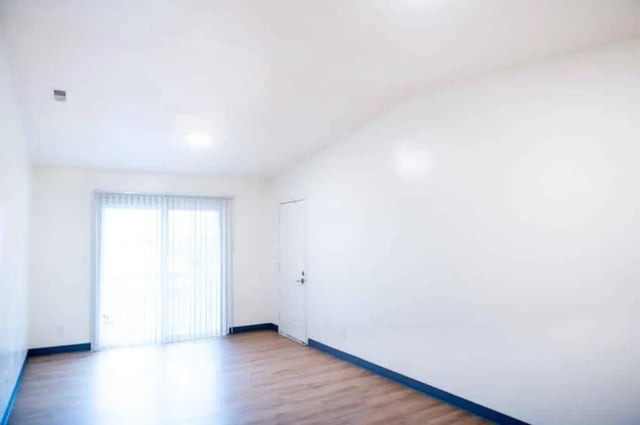 Empty room with sliding glass door and door living room at Silvertree Communities in Muncie Student Accommodation