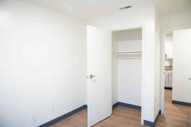 Empty closet with hanging rod and doorway bedroom at Silvertree Communities in Muncie Student Accommodation