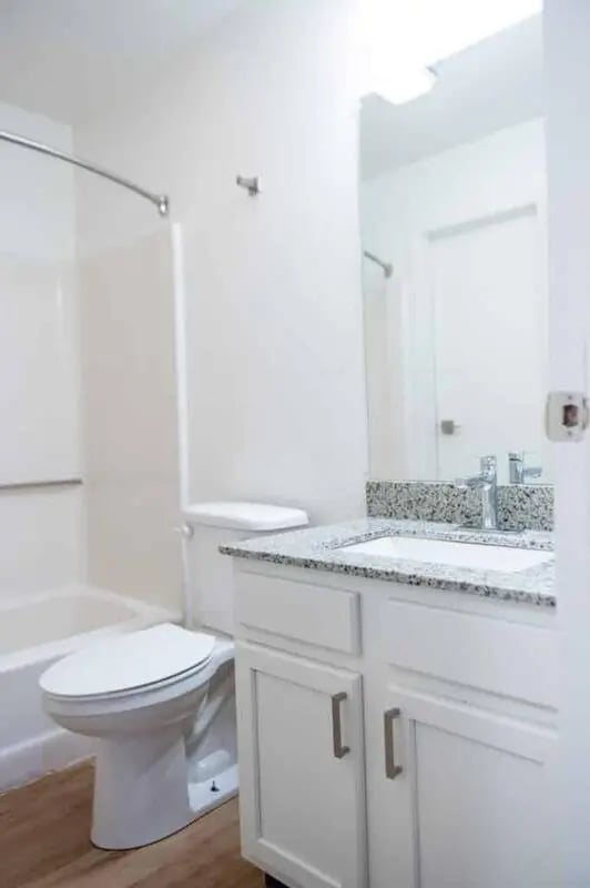 White toilet bathtub granite vanity bathroom at Silvertree Communities in Muncie Student Accommodation