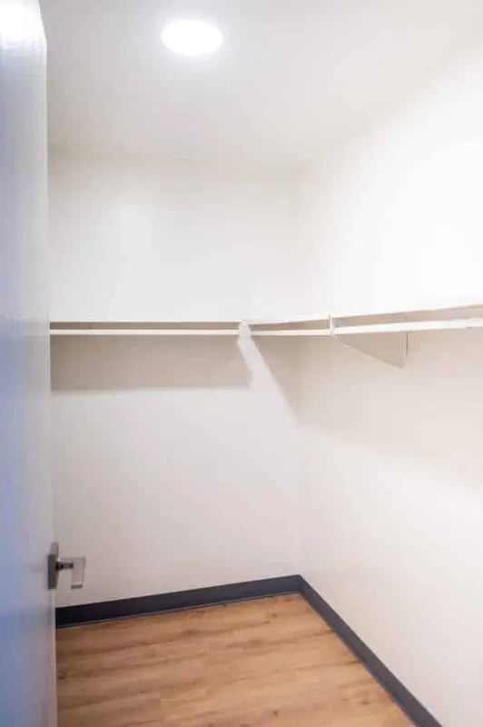 Empty closet with shelves and wood floor at Silvertree Communities in Muncie Student Accommodation