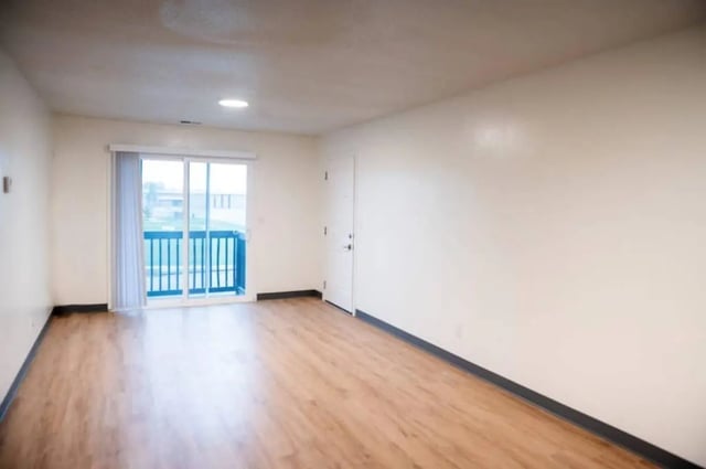 Sliding door balcony and white door Living Room at Silvertree Communities in Muncie Student Accommodation