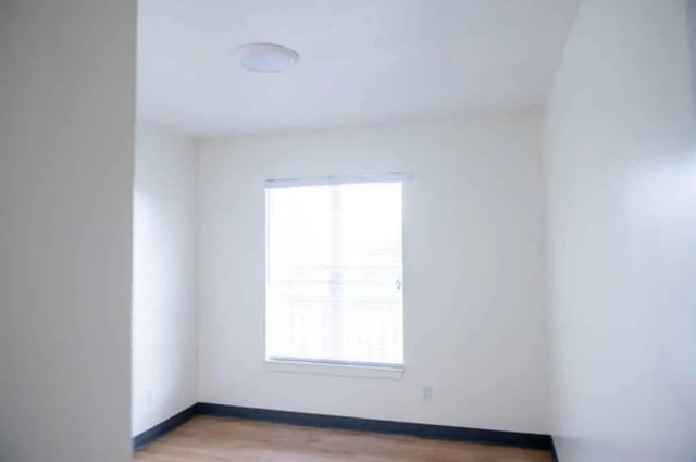 Empty room with window and wood floor bedroom at Silvertree Communities in Muncie Student Accommodation