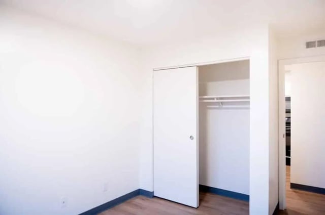 Sliding closet with hanging rod empty bedroom at Silvertree Communities in Muncie Student Accommodation
