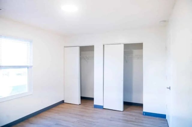 White closets window wood floor bedroom at Silvertree Communities in Muncie Student Accommodation