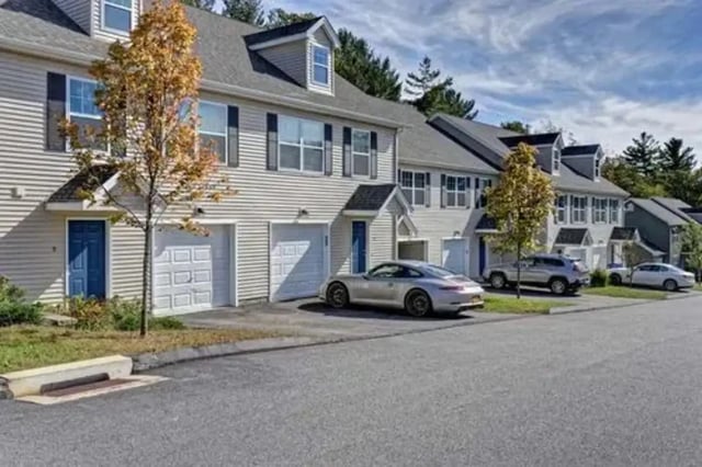 Townhouses with garages and cars exterior at Meadowbrook Gardens