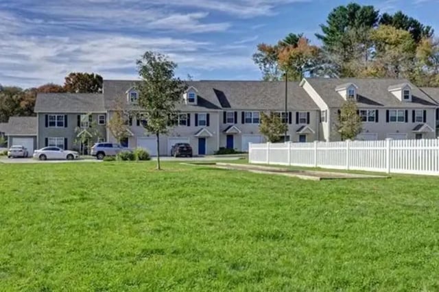 Townhouses with cars in driveway exterior at Meadowbrook Gardens
