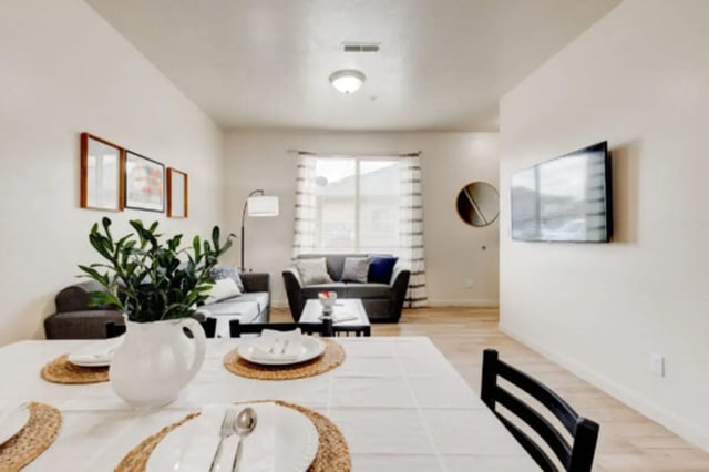 Dining table with place settings living room living room at The Gates in Rexburg Student Accommodation