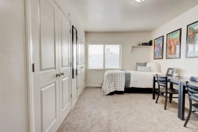 White closets bed desks framed art bedroom at The Gates in Rexburg Student Accommodation