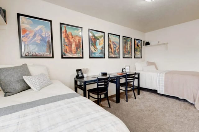 Two beds desks and framed posters bedroom at The Gates in Rexburg Student Accommodation