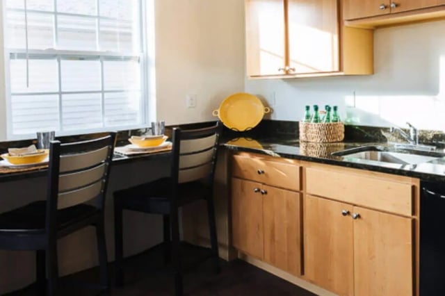 Bar stools with bowls and bottles kitchen at The Gates in East Lansing Student Accommodation