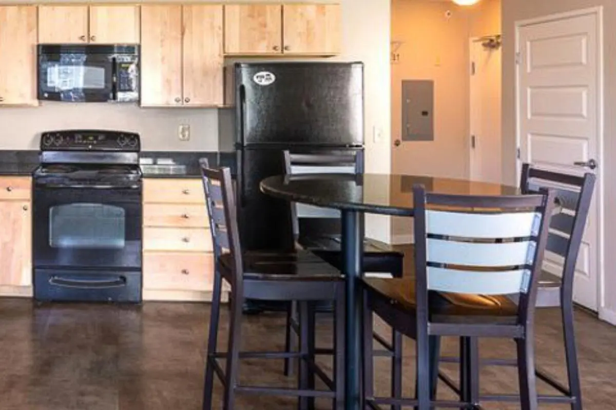 Kitchen with dining table and chairs kitchen at The Gates in East Lansing Student Accommodation