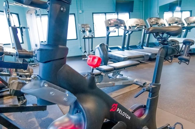 Spin bike treadmills and weight rack gym at The Gates in East Lansing Student Accommodation