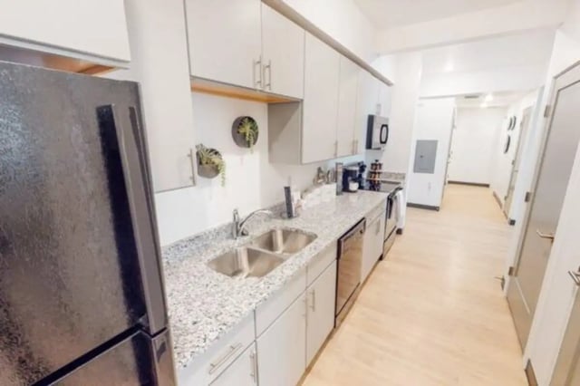 Modern kitchen with stainless steel appliances and white cabinets kitchen at The Green on Campus Drive in Orem Student Accommodation