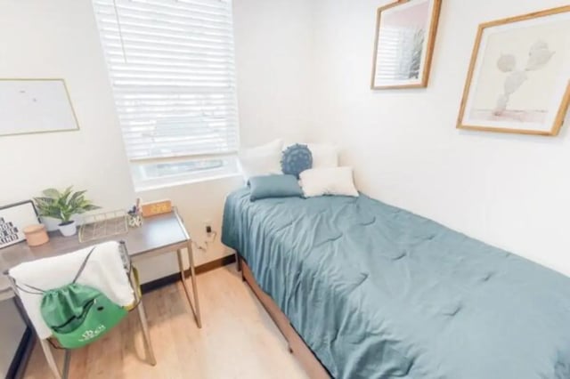 Bed desk and plants bedroom with study area at The Green on Campus Drive in Orem Student Accommodation