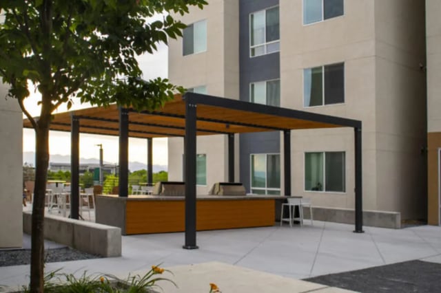 Pergola with grills seating and building exterior at The Green on Campus Drive - Building 4 in Orem Student Accommodation