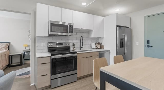 Kitchen with stainless steel appliances and light wood cabinets Kitchen at Unite Student Housing in Salt Lake City Student Accommodation