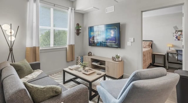Sofa television coffee table and chair living room at Unite Student Housing in Salt Lake City Student Accommodation