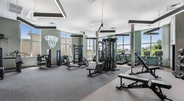 Weight machines treadmills and benches gym interior at Unite Student Housing in Salt Lake City Student Accommodation