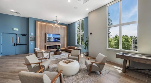 Modern lounge with seating fireplace television and shuffleboard living room at Unite Student Housing in Salt Lake City Student Accommodation