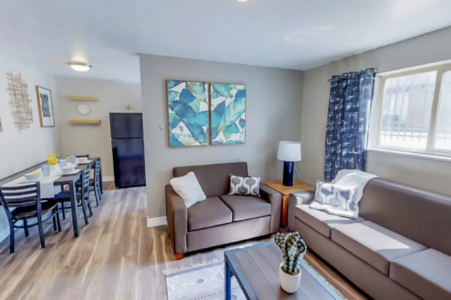 Two sofas dining table and refrigerator living room at Stadium150 Apartments in Provo Student Accommodation