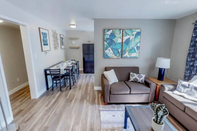 Dining table with chairs and living room with sofa living room at Stadium150 Apartments in Provo Student Accommodation