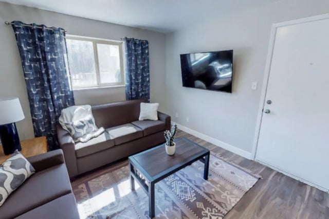 Sofa coffee table rug television and door living room at Stadium150 Apartments in Provo Student Accommodation