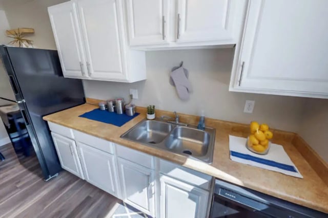 Black refrigerator double sink oven kitchen at Stadium150 Apartments in Provo Student Accommodation