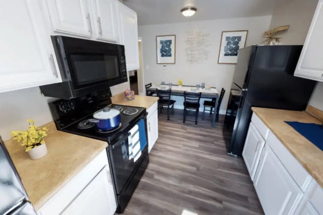 Kitchen with stove microwave refrigerator and dining table kitchen at Stadium150 Apartments in Provo Student Accommodation
