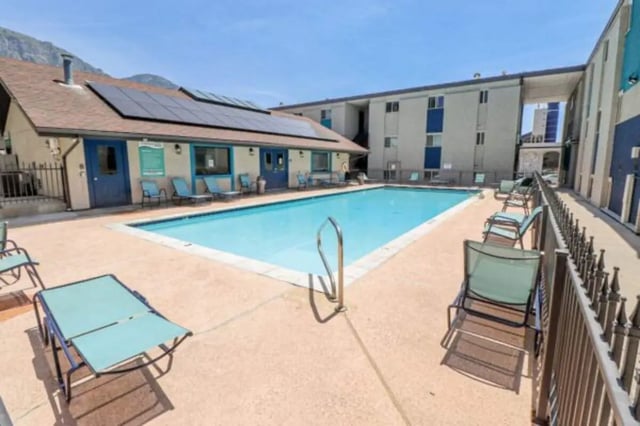 Pool with lounge chairs and solar panels Exterior at Stadium150 Apartments in Provo Student Accommodation