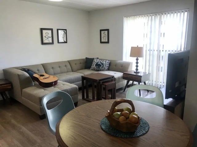Sectional sofa guitar artwork television living room at Park Place Apartments in Provo Student Accommodation