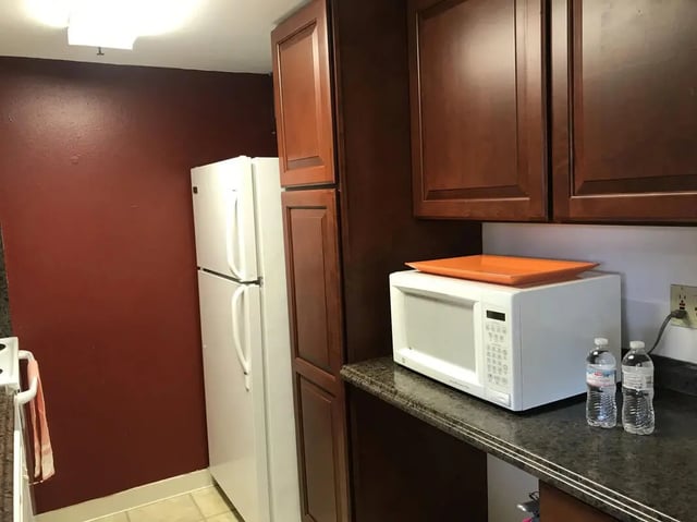 White refrigerator microwave dark cabinets kitchen at Park Place Apartments in Provo Student Accommodation