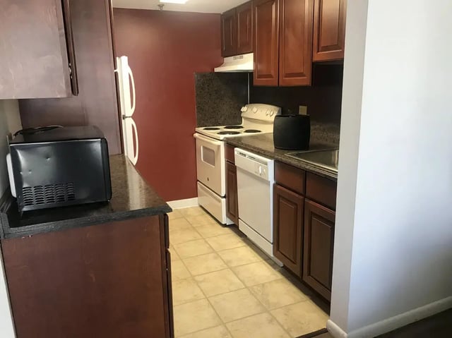 Microwave refrigerator stove dishwasher cabinets kitchen at Park Place Apartments in Provo Student Accommodation